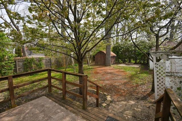 313 N Jackson St, Waukegan, IL 60085 - deck featuring a fenced backyard, a shed, and an outdoor structure