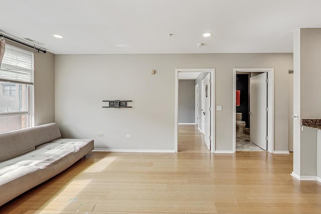 living area with light wood-type flooring, baseboards, and recessed lighting