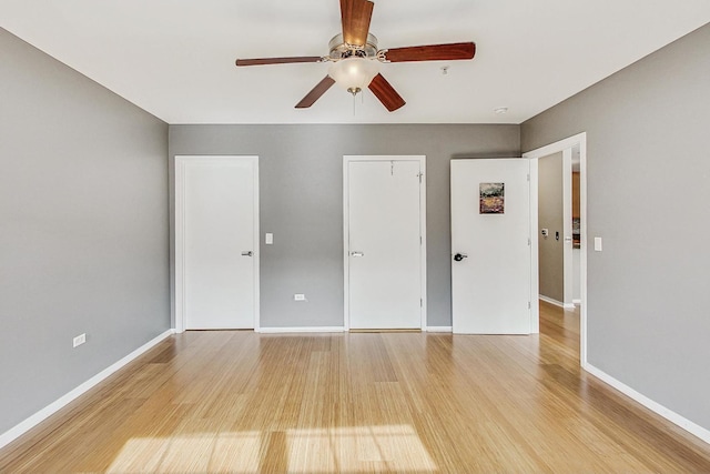 unfurnished bedroom with light wood finished floors, baseboards, and a ceiling fan
