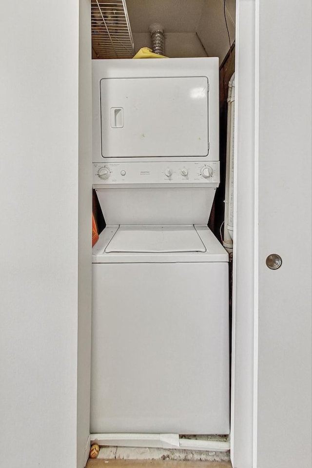 laundry room with stacked washing machine and dryer