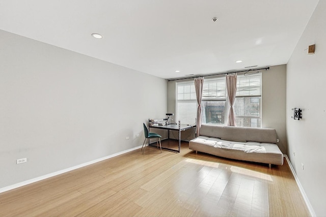 living area featuring wood finished floors, baseboards, recessed lighting, and an office area
