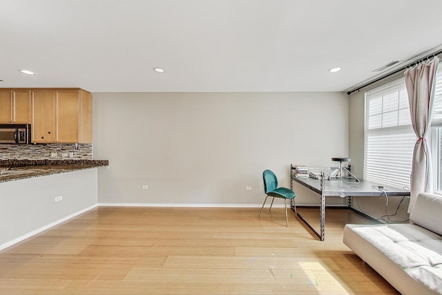 office space with light wood-style flooring, recessed lighting, and baseboards