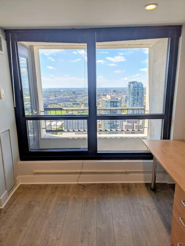 detailed view of a view of city, baseboards, wood finished floors, and recessed lighting