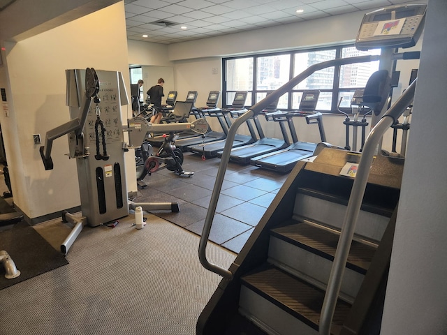 exercise room featuring a drop ceiling