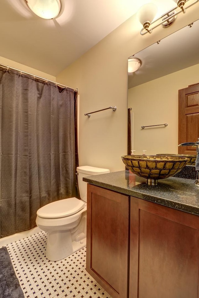 bathroom featuring vanity, toilet, tile patterned floors, and a shower with shower curtain