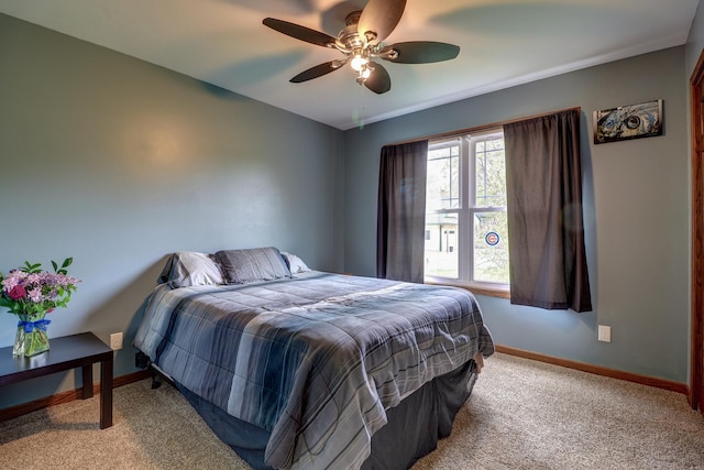 bedroom with carpet flooring, baseboards, and a ceiling fan