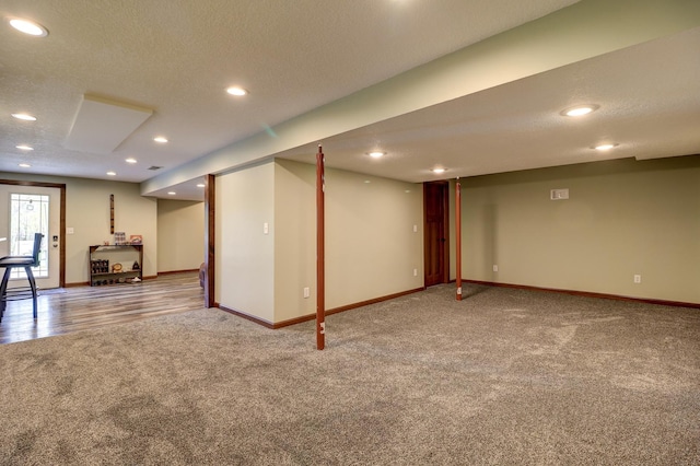 basement with carpet, baseboards, recessed lighting, and a textured ceiling