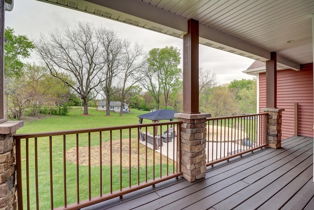 wooden deck featuring a yard and an outdoor structure