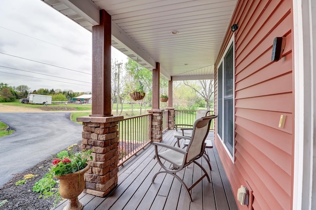 wooden terrace featuring covered porch