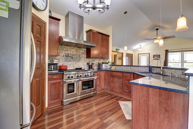 kitchen with stainless steel appliances, wall chimney exhaust hood, a sink, dark wood-type flooring, and decorative backsplash