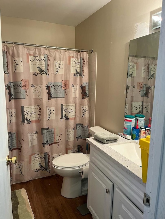 full bathroom with wood finished floors, toilet, vanity, and a shower with curtain