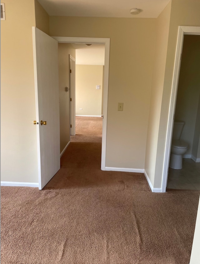 hall with carpet floors and baseboards