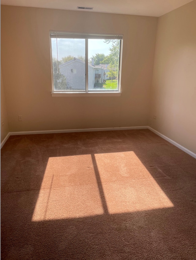 unfurnished room with carpet floors and baseboards