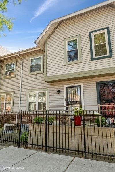 rear view of house with a fenced front yard