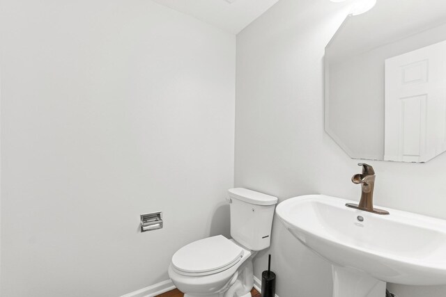 10616 Rushmore Ln, Huntley, IL 60142 - half bath featuring a sink, toilet, and baseboards