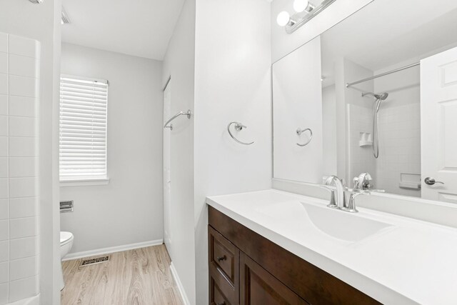 10616 Rushmore Ln, Huntley, IL 60142 - full bath with vanity, wood finished floors, toilet, a shower, and baseboards