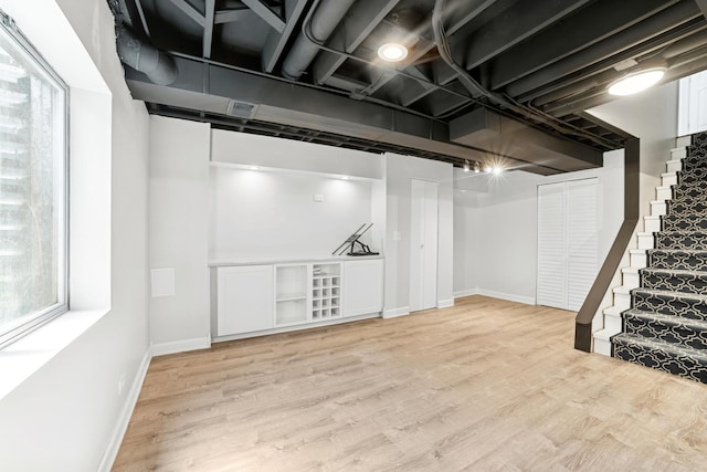 10616 Rushmore Ln, Huntley, IL 60142 - basement featuring stairs, light wood-style flooring, and baseboards