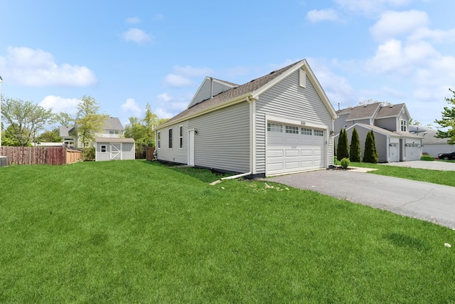 10616 Rushmore Ln, Huntley, IL 60142 - view of property exterior featuring a storage shed, driveway, an attached garage, an outdoor structure, and a shingled roof
