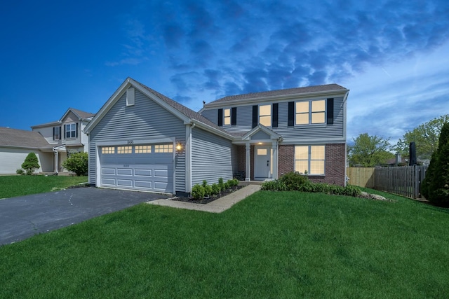 10616 Rushmore Ln, Huntley, IL 60142 - traditional home with a garage, asphalt driveway, and brick siding