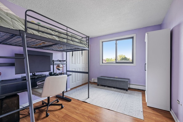 9935 El Cameno Real Dr Unit 3D, Orland Park, IL 60462 - bedroom featuring a baseboard radiator, a textured ceiling, baseboards, and wood finished floors