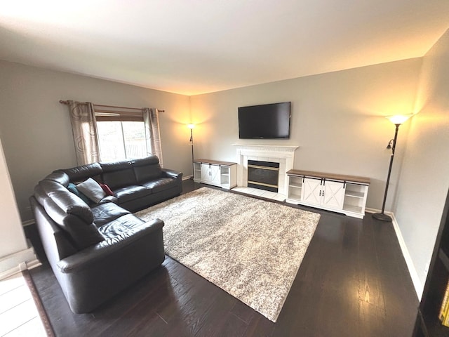 1932 Royal Ln, Aurora, IL 60503 - living area featuring dark wood-style floors, a fireplace with flush hearth, and baseboards