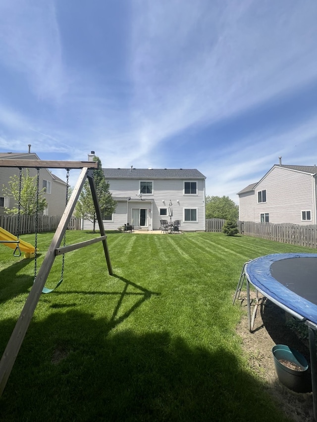 1932 Royal Ln, Aurora, IL 60503 - rear view of property with a trampoline