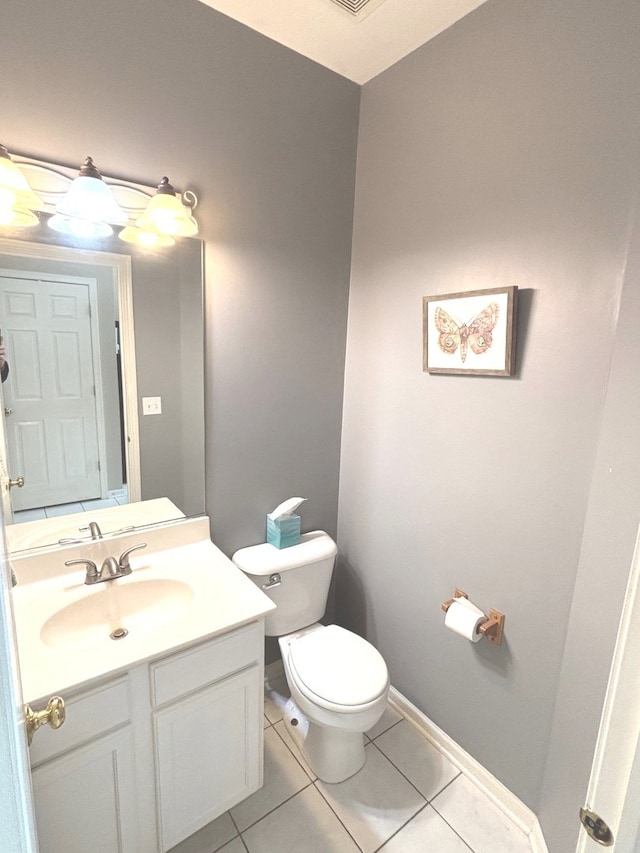 1932 Royal Ln, Aurora, IL 60503 - bathroom featuring toilet, vanity, tile patterned flooring, and baseboards