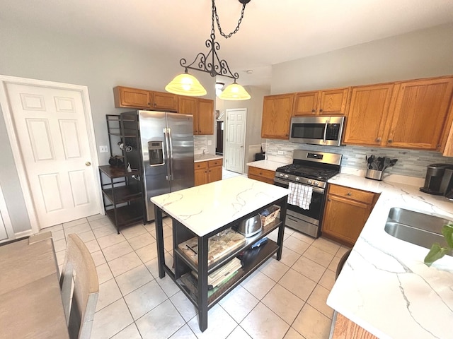 1932 Royal Ln, Aurora, IL 60503 - kitchen featuring stainless steel appliances, decorative backsplash, brown cabinets, light tile patterned floors, and hanging light fixtures