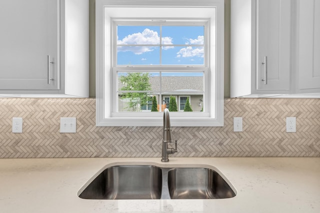 1608 E Horizon Ln, Urbana, IL 61802 - kitchen with a sink, healthy amount of natural light, white cabinetry, and light stone counters