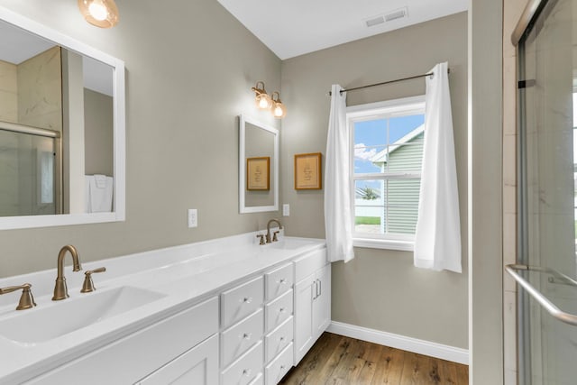 1608 E Horizon Ln, Urbana, IL 61802 - bathroom with a stall shower, wood finished floors, baseboards, and double vanity