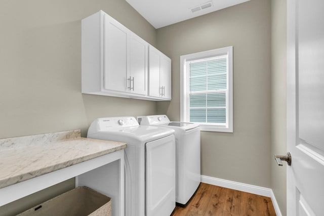 1608 E Horizon Ln, Urbana, IL 61802 - washroom with washer and clothes dryer, baseboards, cabinet space, and wood finished floors