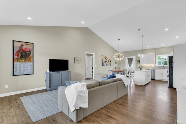 1608 E Horizon Ln, Urbana, IL 61802 - living room with dark wood finished floors, high vaulted ceiling, a chandelier, recessed lighting, and baseboards