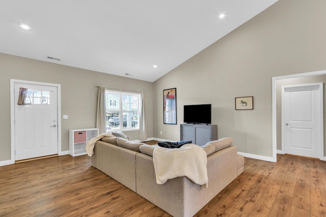 1608 E Horizon Ln, Urbana, IL 61802 - living area featuring light wood finished floors, baseboards, high vaulted ceiling, and recessed lighting