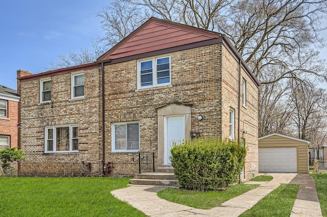 view of front of property featuring brick siding, driveway, a garage, an outbuilding, and a front lawn