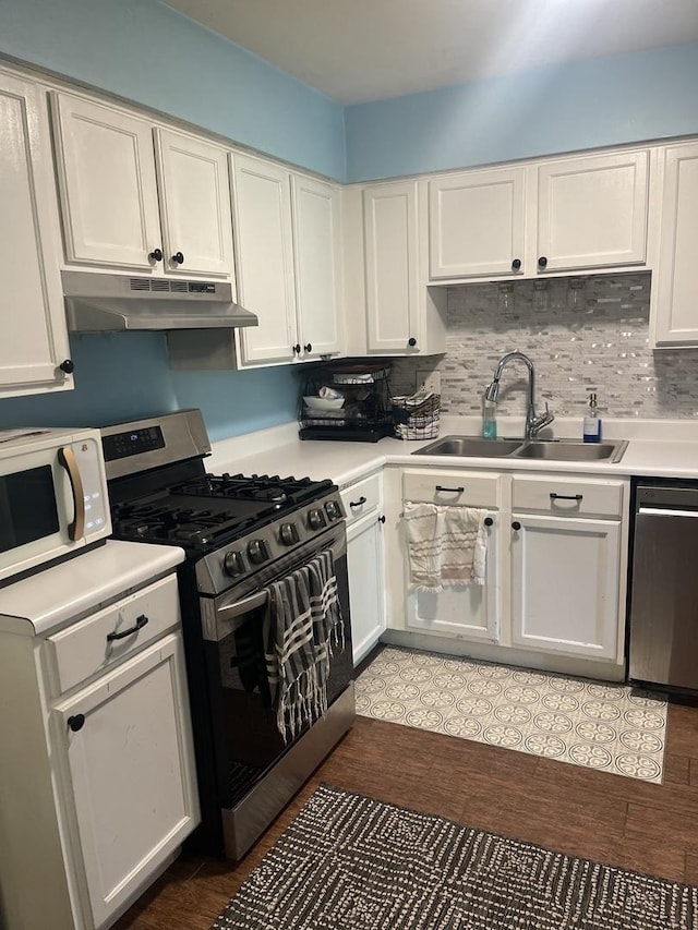 19380 Wolf Rd Unit 5, Mokena, IL 60448 - kitchen with under cabinet range hood, appliances with stainless steel finishes, a sink, white cabinetry, and light countertops