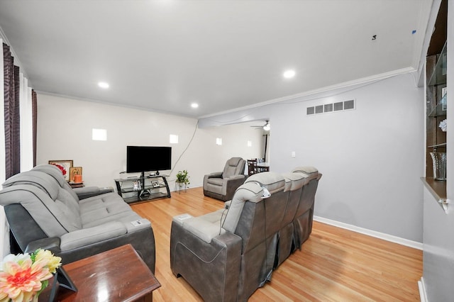 living area with light wood-style flooring, a ceiling fan, ornamental molding, recessed lighting, and baseboards