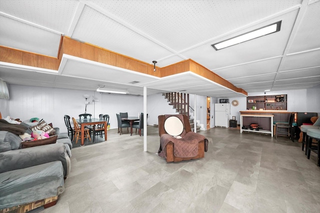 living room featuring stairway and a bar