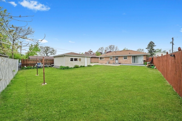 rear view of house featuring a patio and an outbuilding