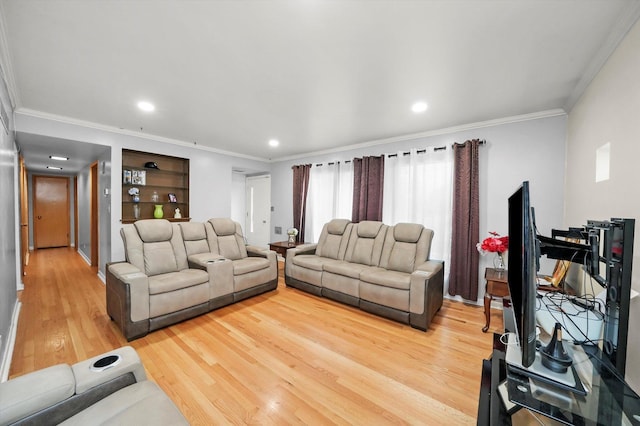 living room featuring light wood-style floors, crown molding, and recessed lighting