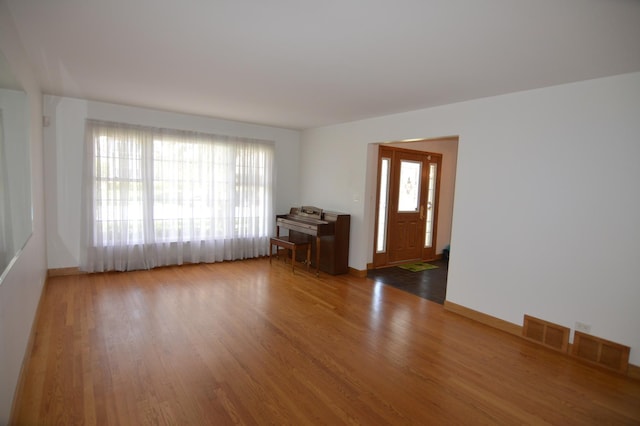 2405 E Miner St, Arlington Heights, IL 60004 - unfurnished living room with wood finished floors and baseboards