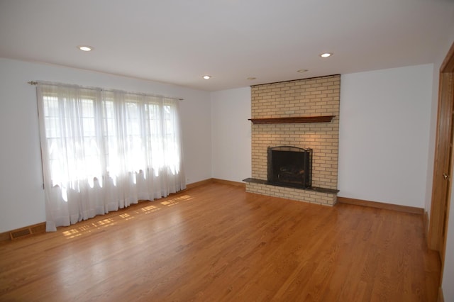 2405 E Miner St, Arlington Heights, IL 60004 - unfurnished living room featuring light wood finished floors, baseboards, a fireplace, and recessed lighting