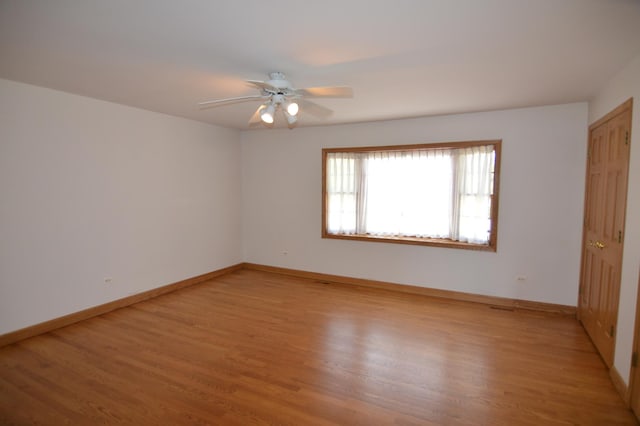 2405 E Miner St, Arlington Heights, IL 60004 - unfurnished bedroom featuring light wood-type flooring, baseboards, and a ceiling fan