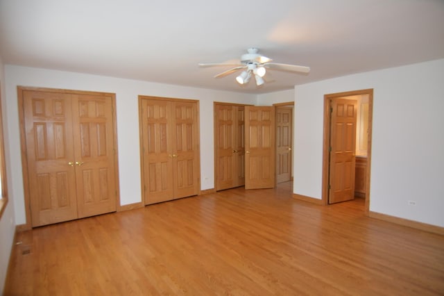 2405 E Miner St, Arlington Heights, IL 60004 - unfurnished bedroom featuring two closets, light wood-type flooring, baseboards, and a ceiling fan