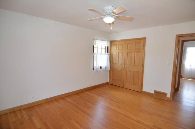 2405 E Miner St, Arlington Heights, IL 60004 - unfurnished bedroom with multiple windows, light wood-style floors, and baseboards