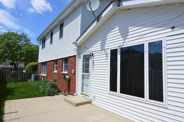 2405 E Miner St, Arlington Heights, IL 60004 - view of home's exterior with a patio area, brick siding, fence, and central air condition unit