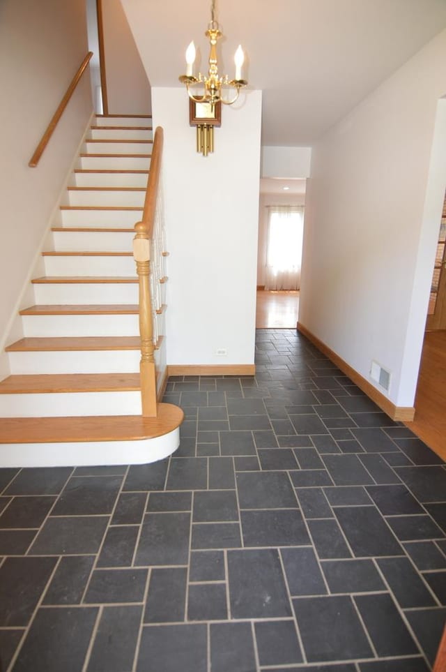 2405 E Miner St, Arlington Heights, IL 60004 - stairway featuring baseboards and a chandelier