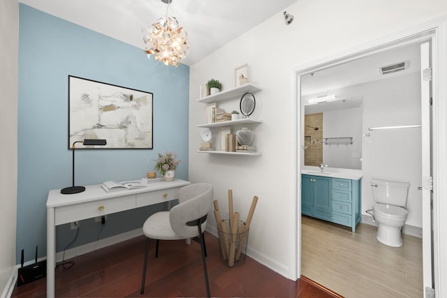 home office with wood finished floors, a sink, a chandelier, and baseboards