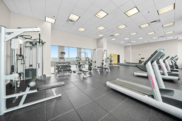 gym with a paneled ceiling