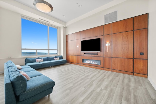 living room with light wood-type flooring and baseboards
