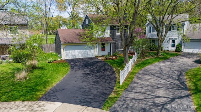 view of front of property featuring asphalt driveway and a garage